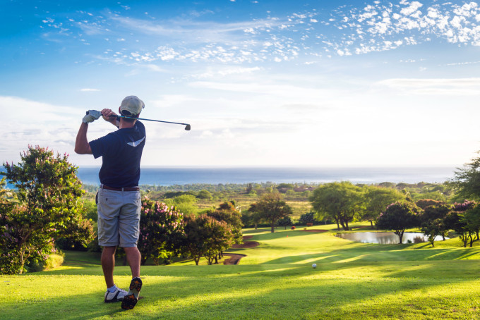 Man hitting golf ball