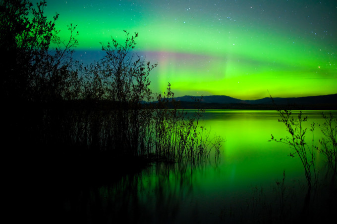 Northern lights mirrored on lake