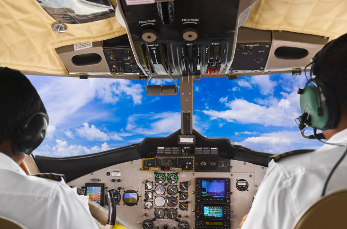 Pilots in a plane cockpit and clear blue sky