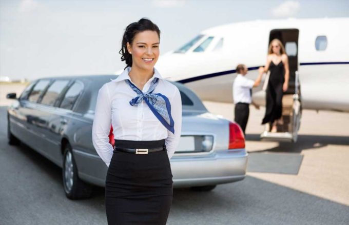 Limousine parked near private jet.