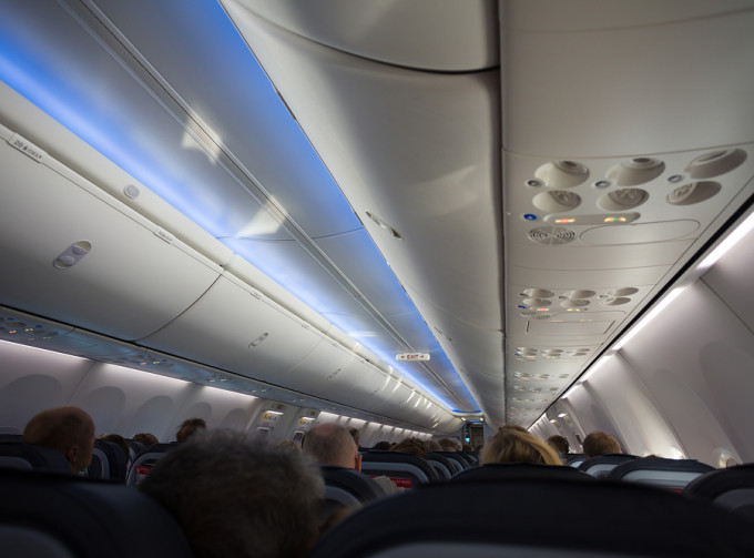 Commercial airplane cabin of people.