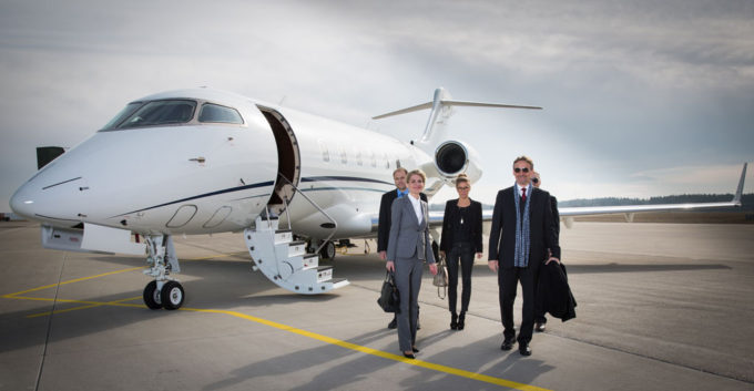 Executive business team leaving a corporate jet.