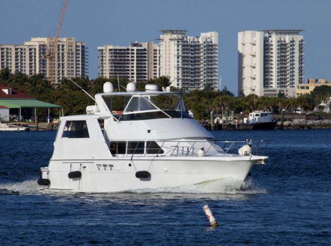Yacht cruising the intercoastal with West Palm Beach as a backdrop.