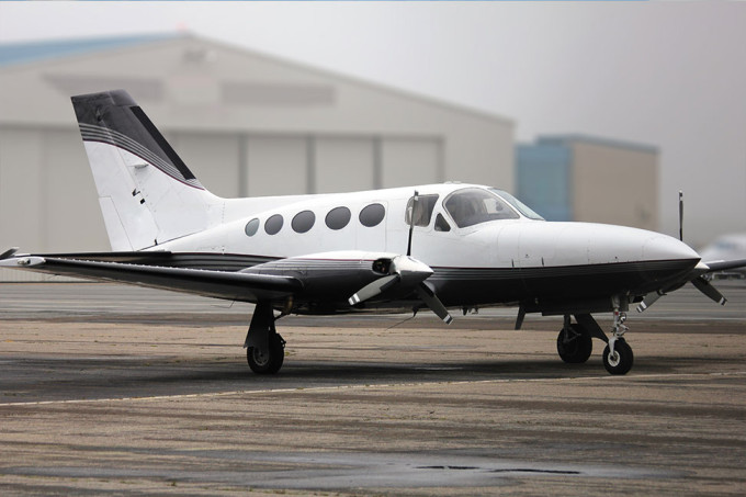 Small plane parked on a general aviation airport tarmac.