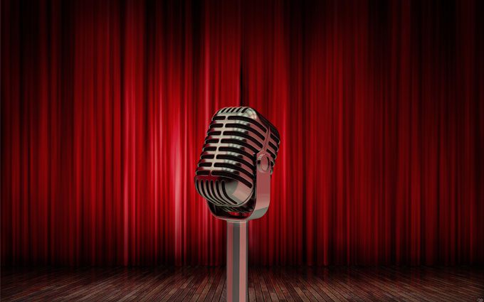  3d illustration studio microphone on a background of red curtains By volodyar