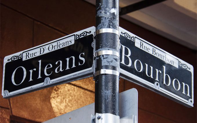 Street signs for Rue D' Orleans and Rue Bourbon in New Orleans, Louisiana